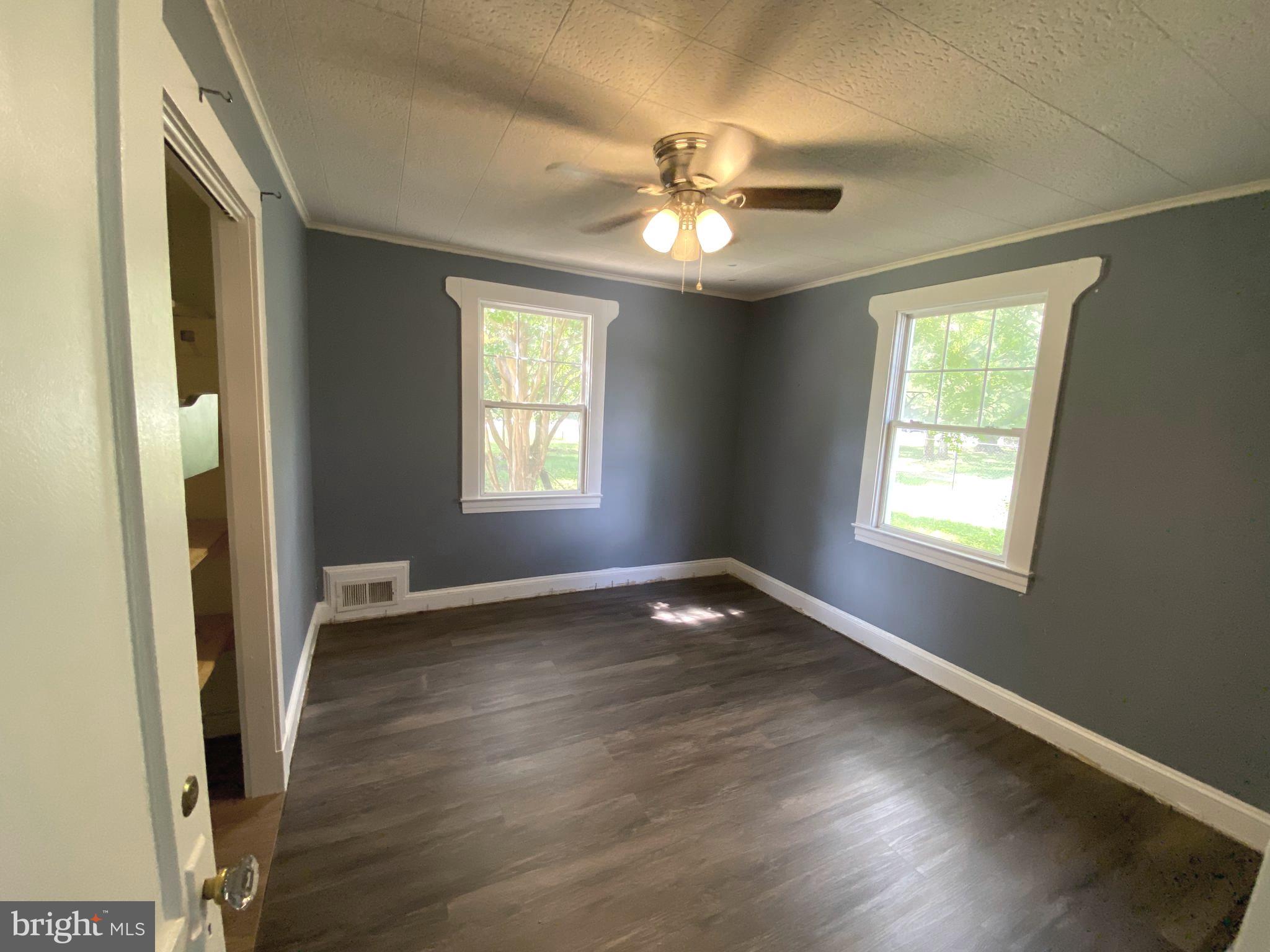 13304 Crain Highway Brandywine, MD 20613 - Photo 12 of 17 a view of an empty room with wooden floor and a window