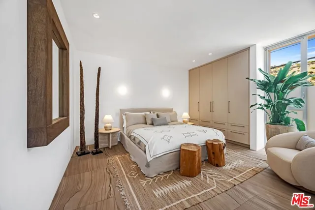 a bedroom with a large bed and a couch