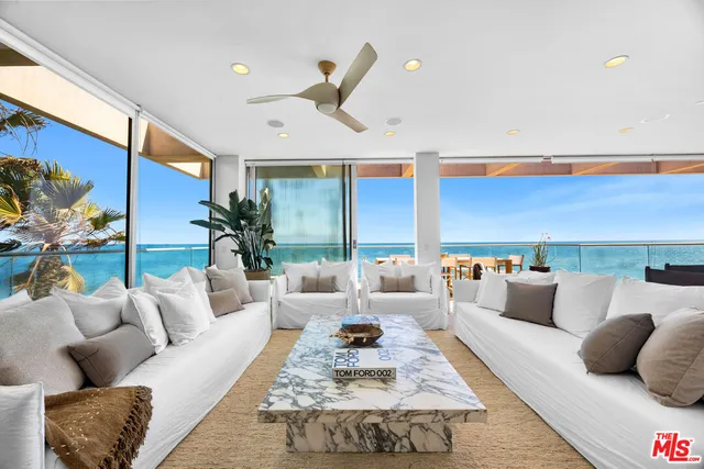 a living room with furniture rug and a large window