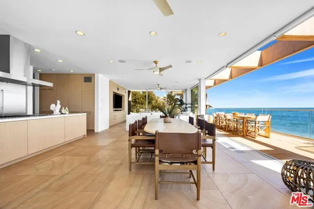 a dining room with wooden floor table and chairs
