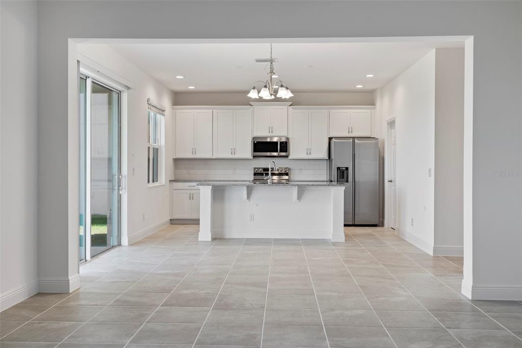 7120 Cherry Pasture Road Groveland, FL 34736 - Photo 7 of 23 a large kitchen with cabinets and stainless steel appliances