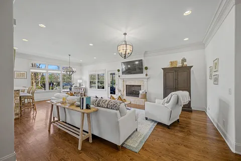 a living room with fireplace furniture and a wooden floor