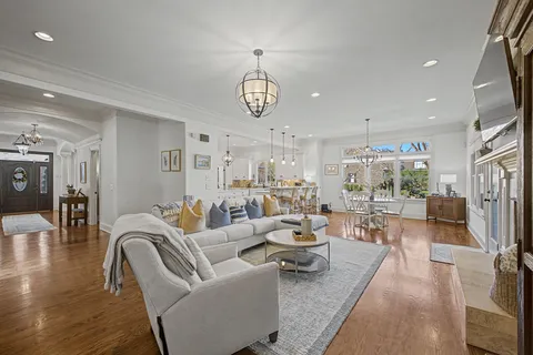a living room with fireplace furniture and a large window