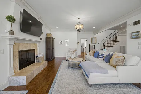 a living room with furniture fireplace and flat screen tv