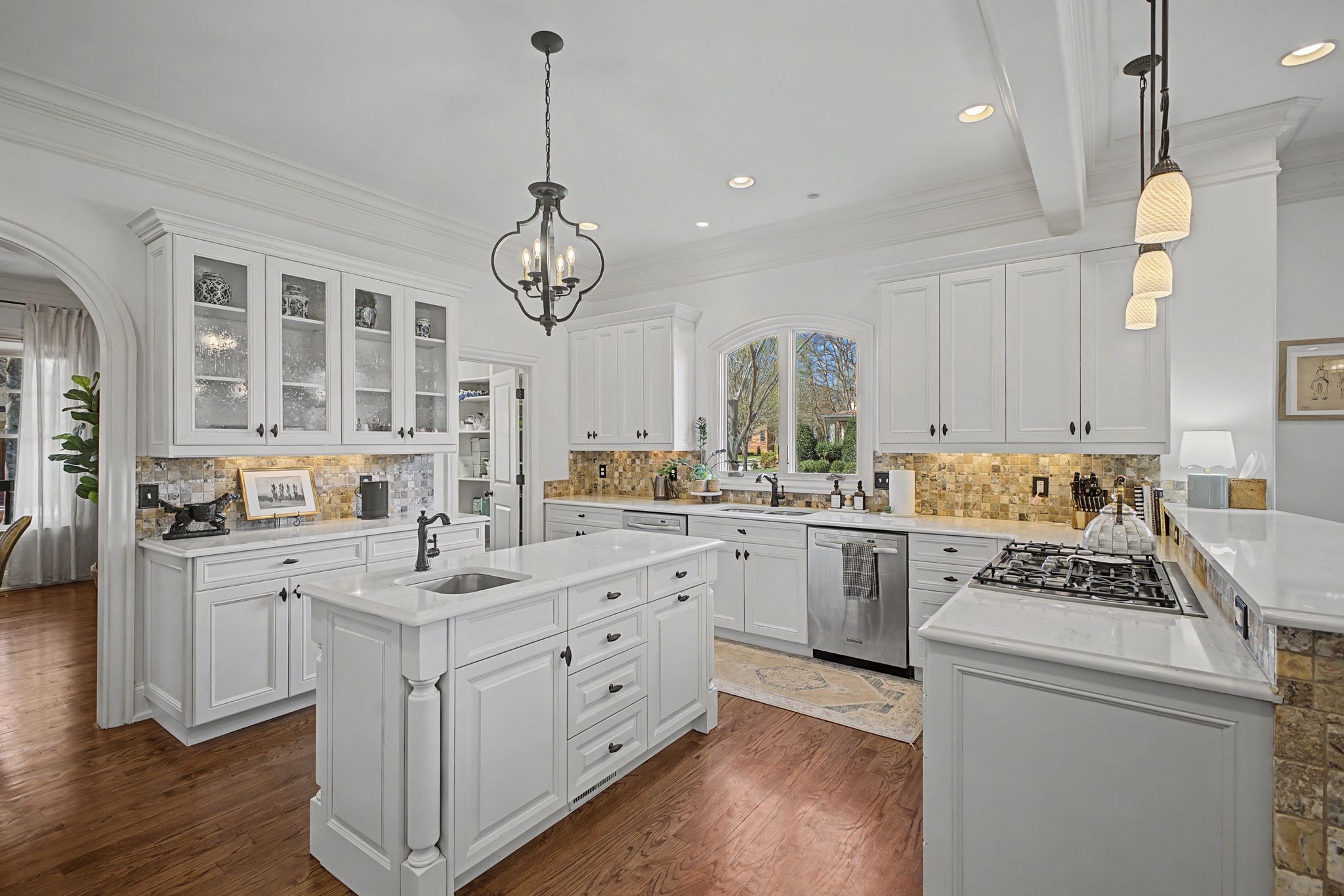 626 Band Drive Franklin, TN 37064 - Photo 18 of 53 a kitchen with a stove a sink dishwasher a refrigerator and a dining table with wooden floor