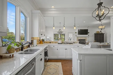 a kitchen with a sink stove and cabinets