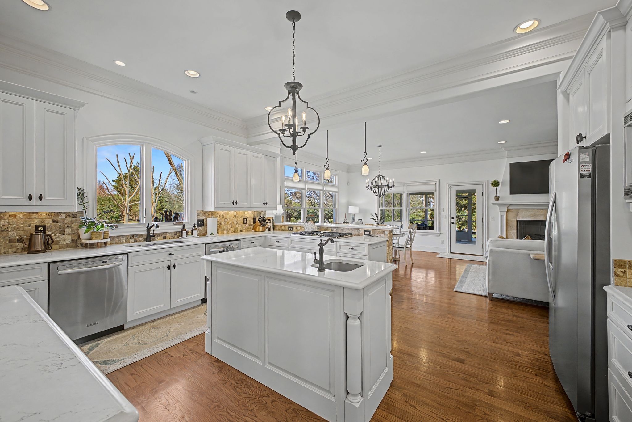 626 Band Drive Franklin, TN 37064 - Photo 22 of 53 a kitchen with stainless steel appliances granite countertop a sink dishwasher and white cabinets with wooden floor