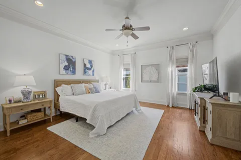a spacious bedroom with a bed and a chandelier