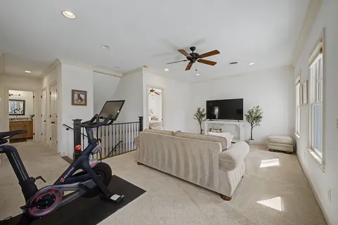 a living room with furniture and a ceiling fan