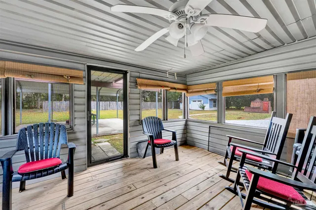 a living room with furniture and large windows