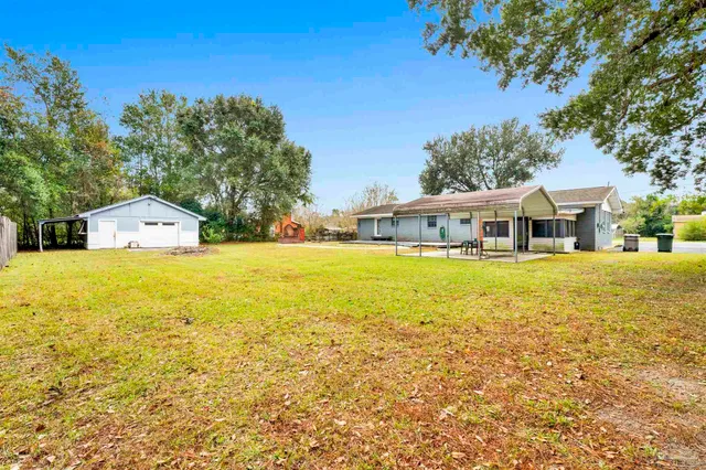 a front view of house with yard and swimming pool