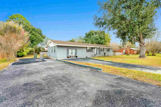 a view of house with outdoor space and swimming pool