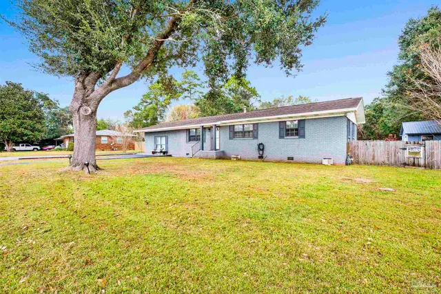 a house view with swimming pool in front of it