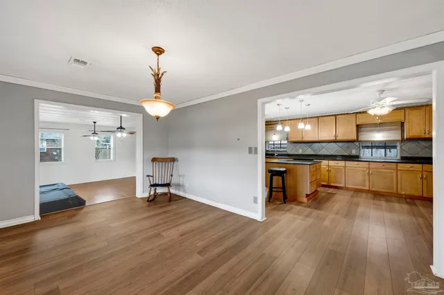a view of kitchen with sink and refrigerator