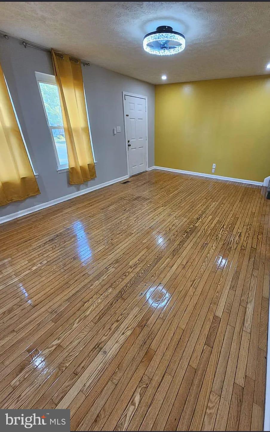 604 Burlington Court Edgewood, MD 21040 - Photo 4 of 7 a view of empty room with window and wooden floor