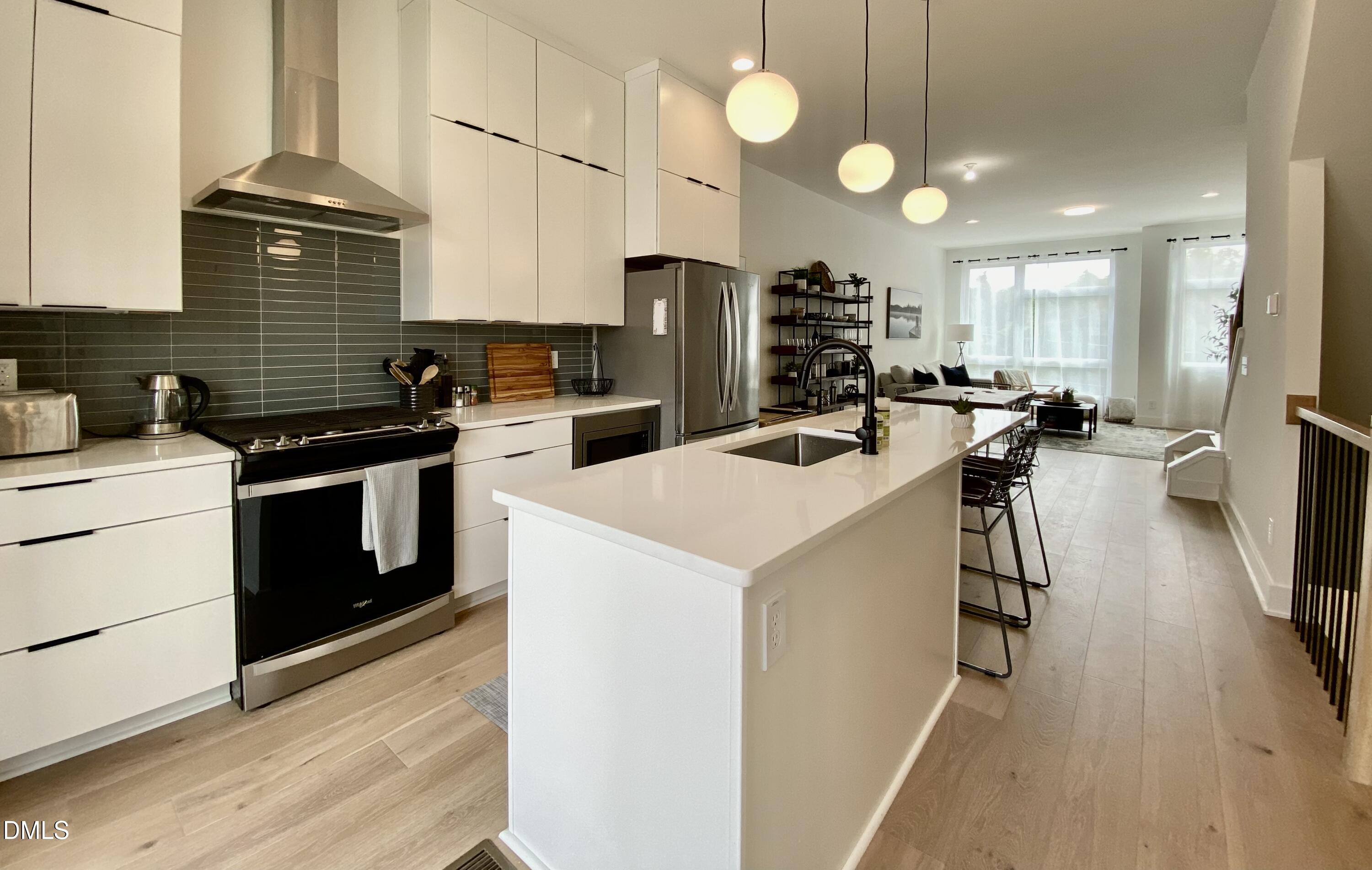 629 North Queen Street Durham, NC 27701 - Photo 14 of 58 a kitchen that has a lot of cabinets a sink and appliances