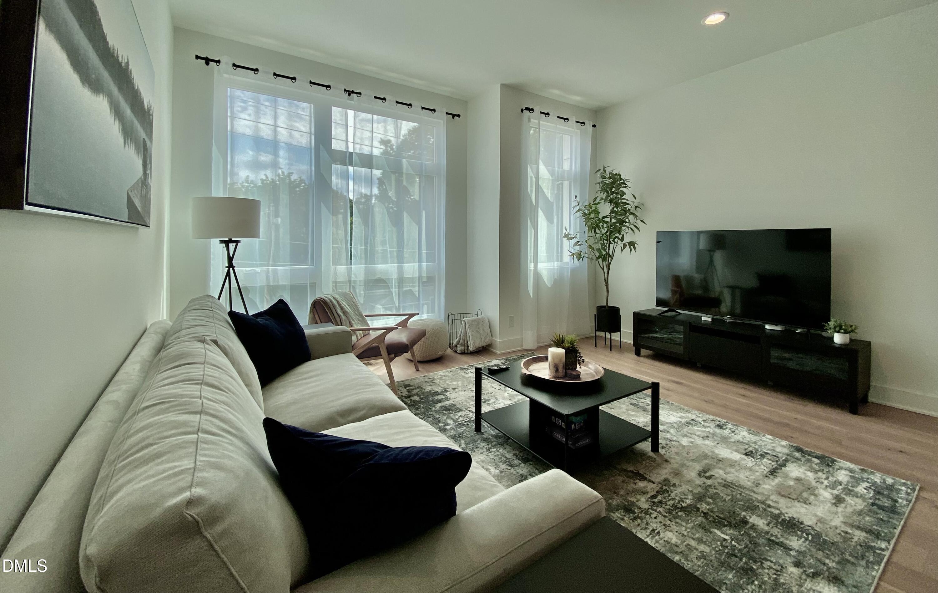 629 North Queen Street Durham, NC 27701 - Photo 22 of 58 a living room with furniture and a flat screen tv