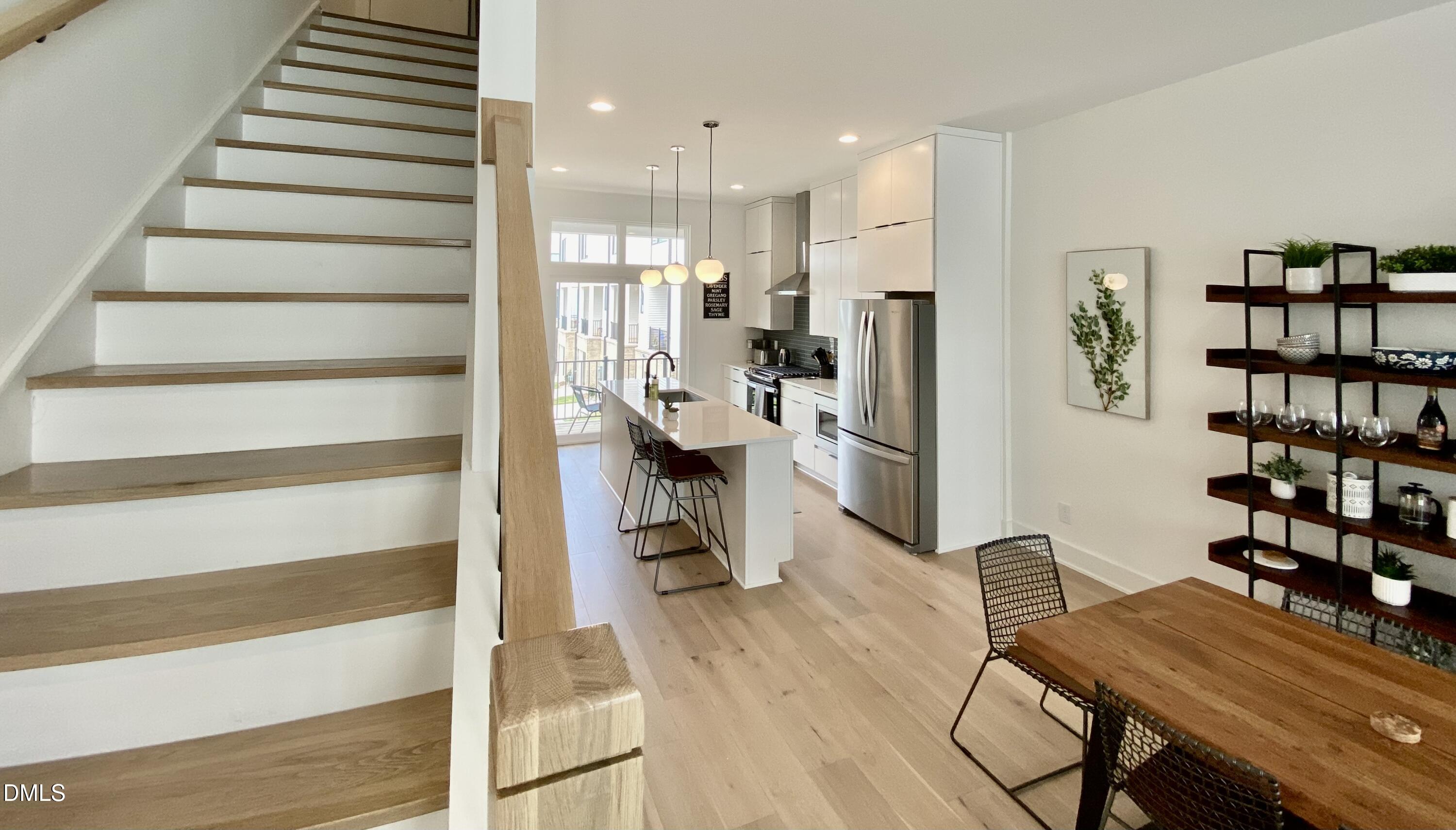 629 North Queen Street Durham, NC 27701 - Photo 25 of 58 a view of a kitchen with furniture and wooden floor