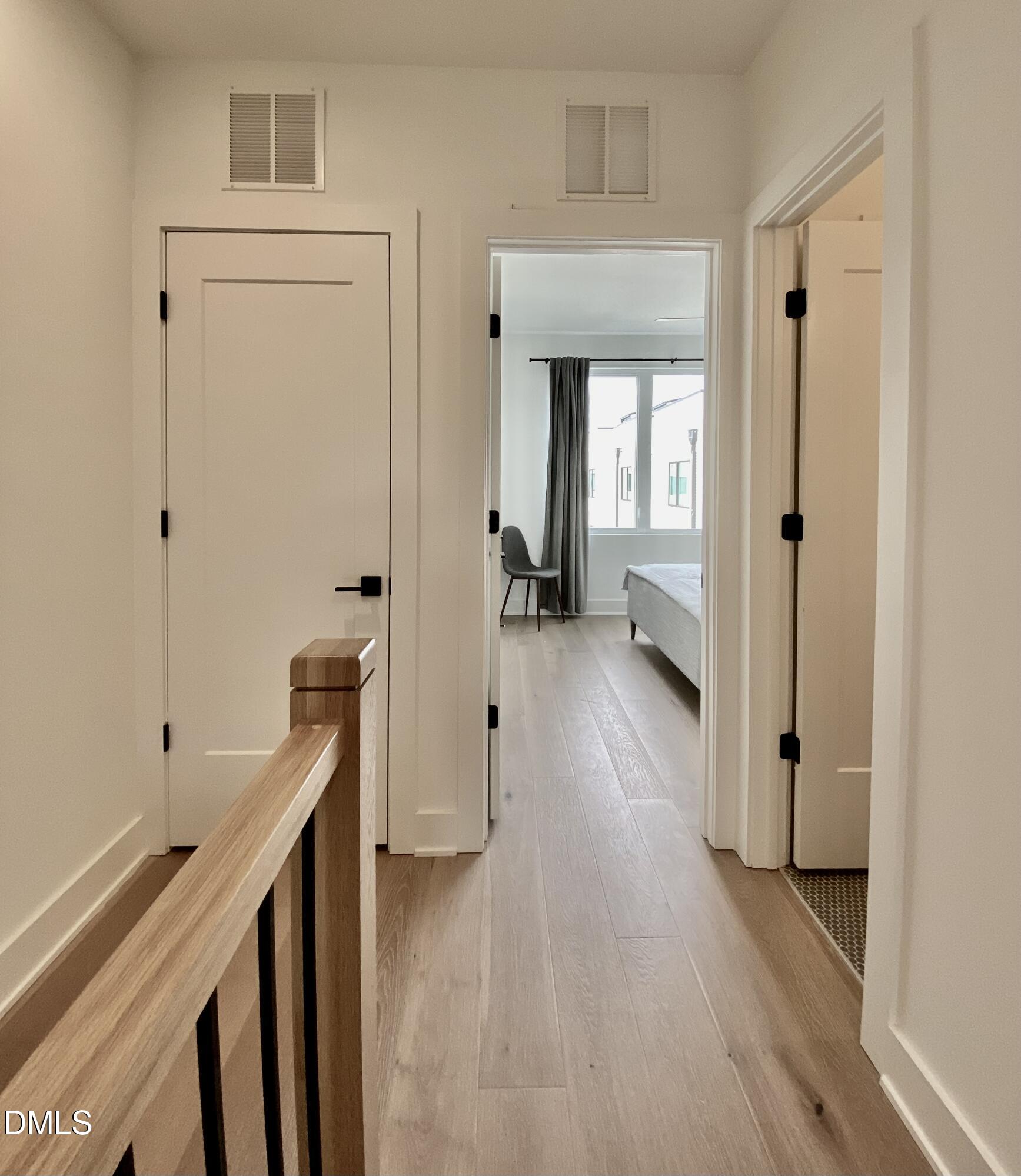 629 North Queen Street Durham, NC 27701 - Photo 28 of 58 a view of a hallway with wooden floor and staircase