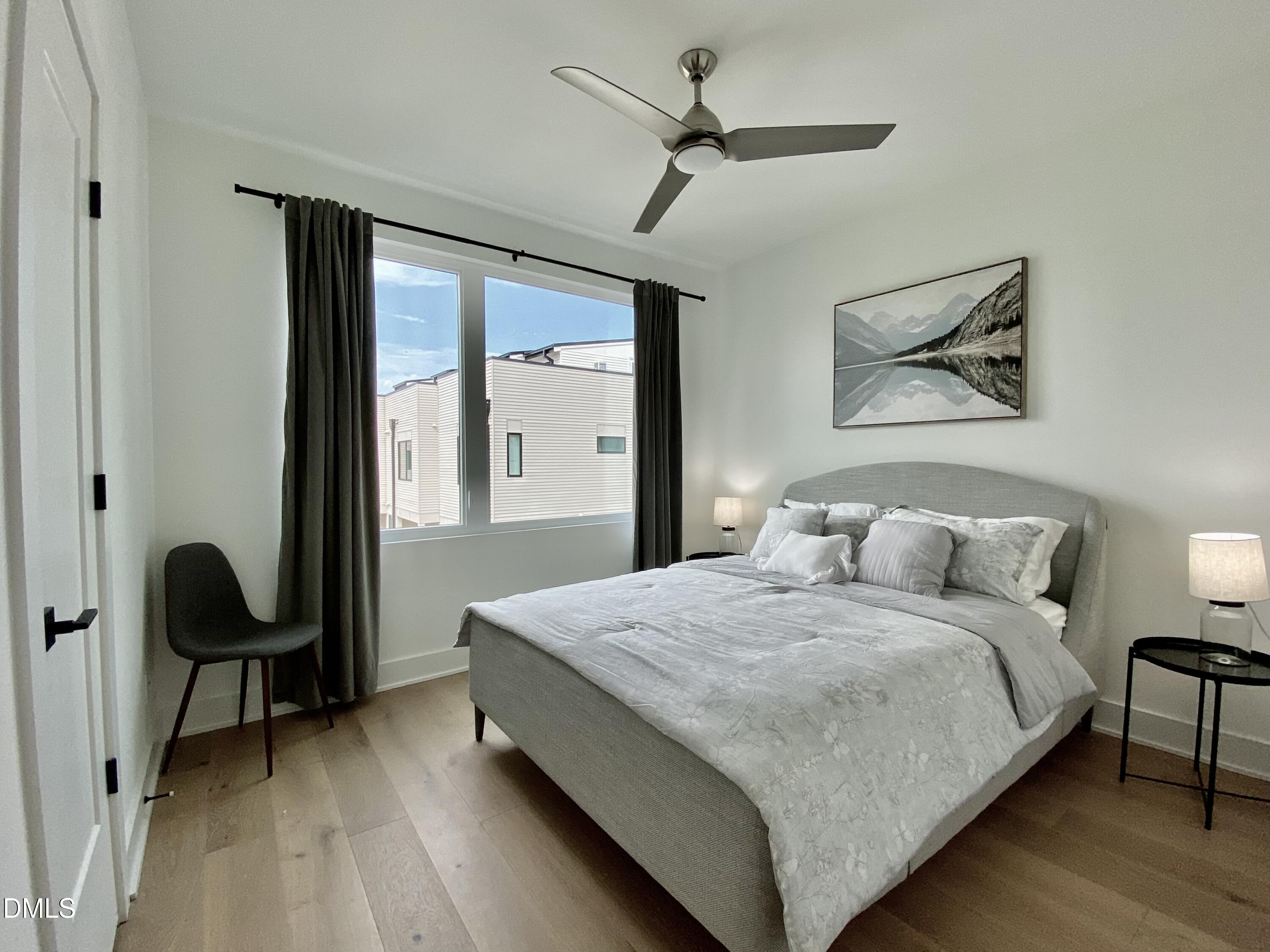 629 North Queen Street Durham, NC 27701 - Photo 29 of 58 a bedroom with a bed and a chandelier