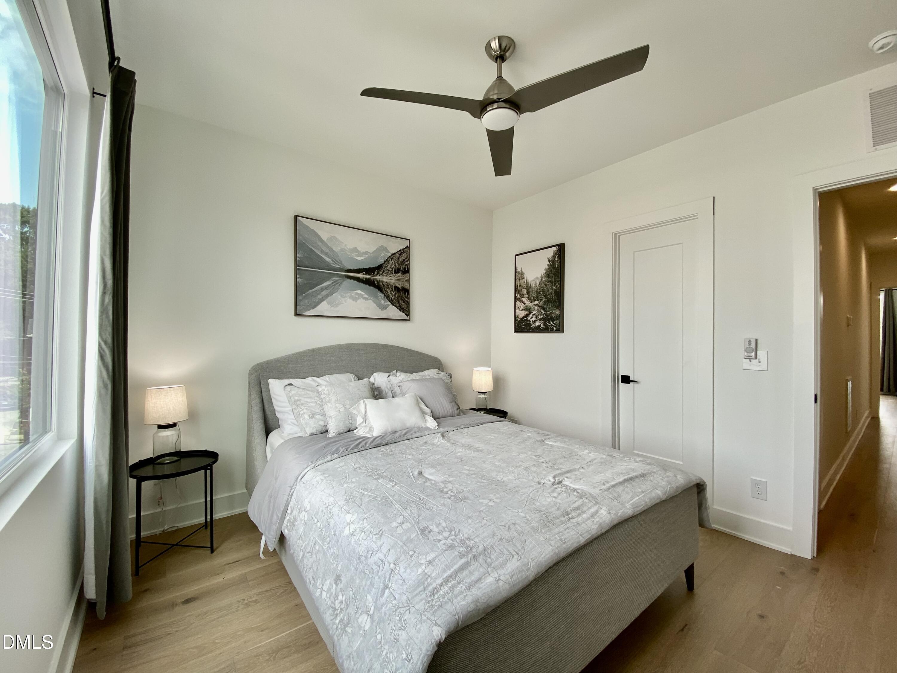 629 North Queen Street Durham, NC 27701 - Photo 30 of 58 a bedroom with a large bed and a chandelier