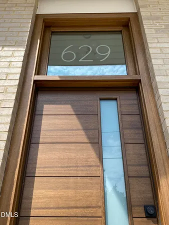 a view of a hallway with wooden floor and entryway