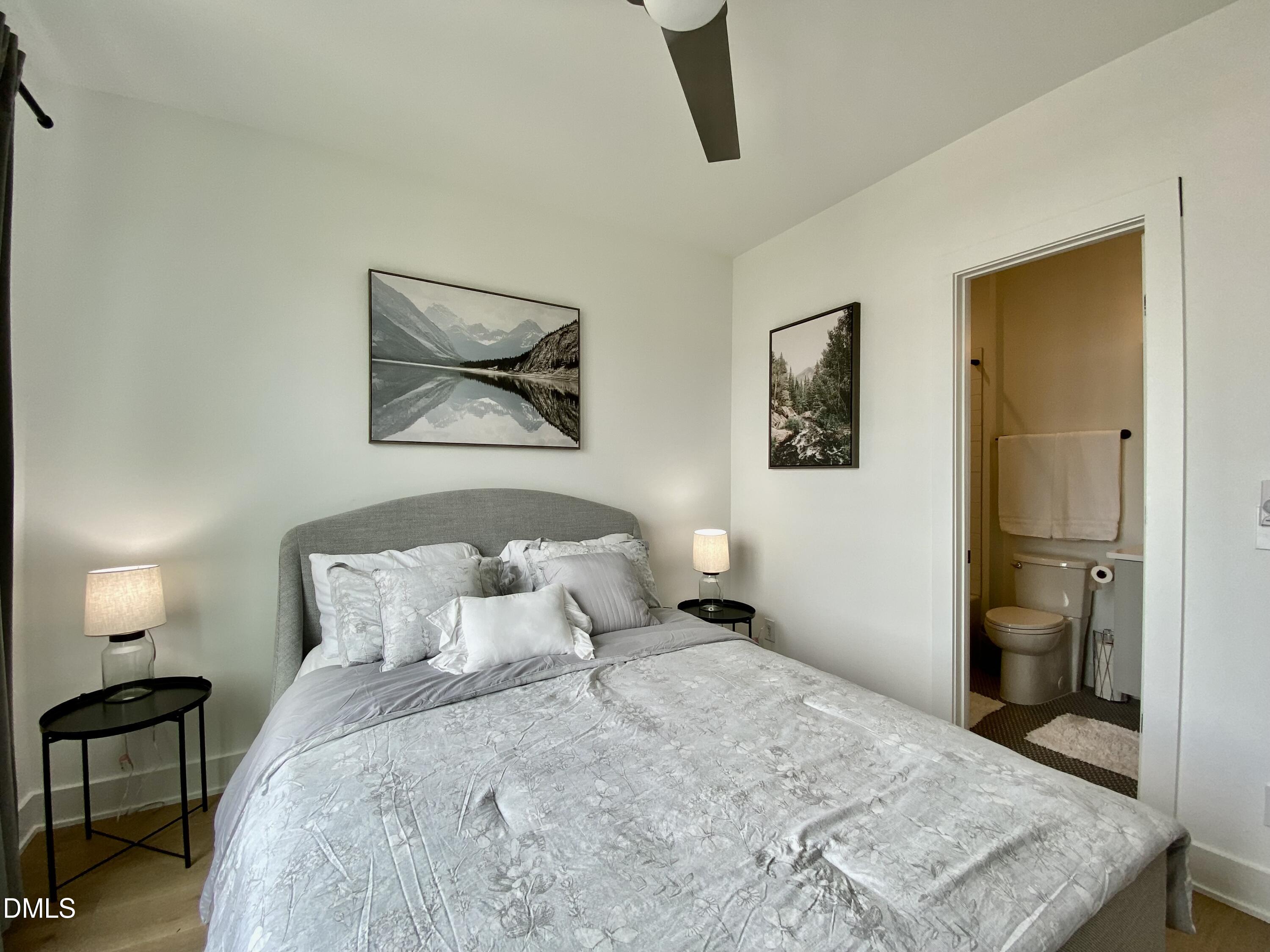 629 North Queen Street Durham, NC 27701 - Photo 31 of 58 a bedroom with a bed and a painting on the wall