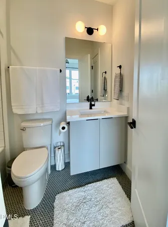 a large bed sitting in a bedroom next to a window