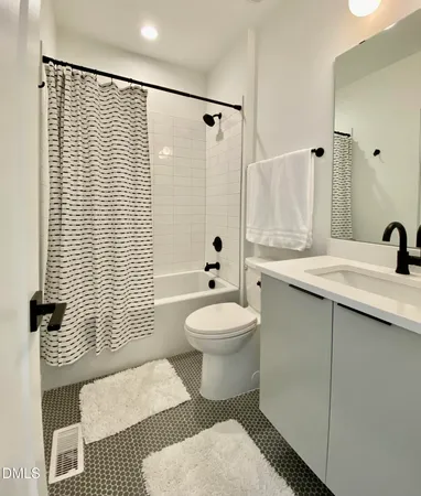 a bedroom with a large bed and a desk