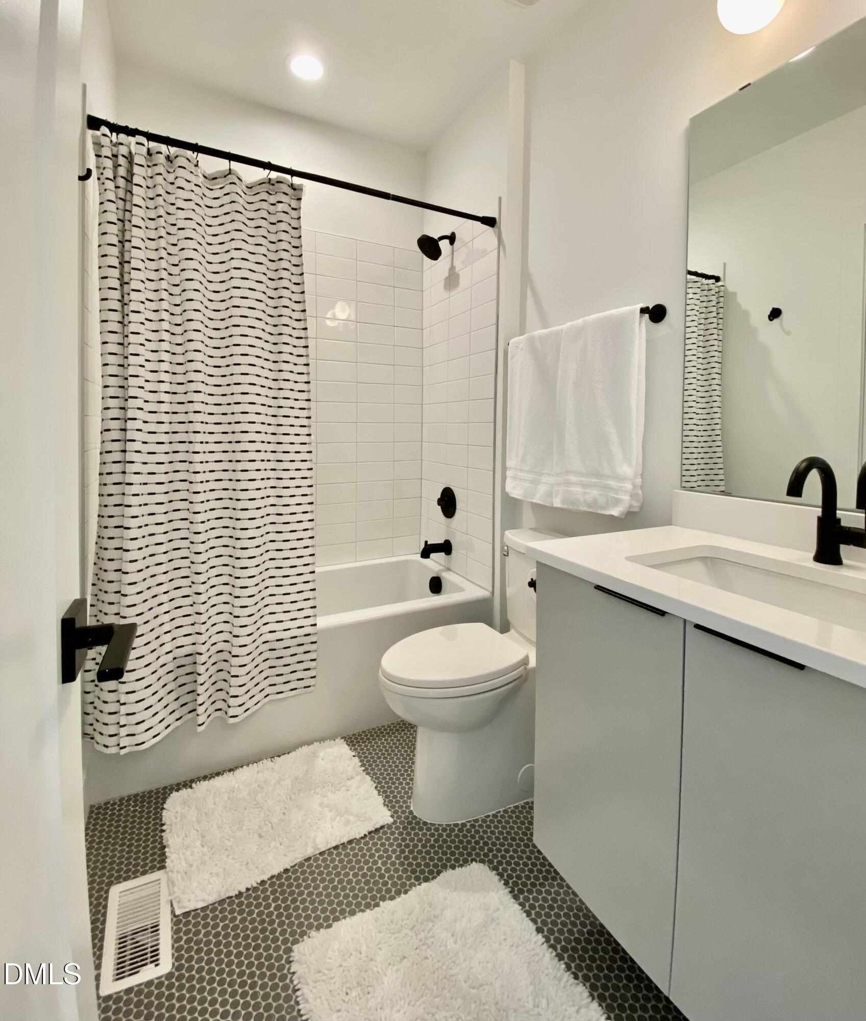 629 North Queen Street Durham, NC 27701 - Photo 34 of 58 a bathroom with a sink toilet and shower