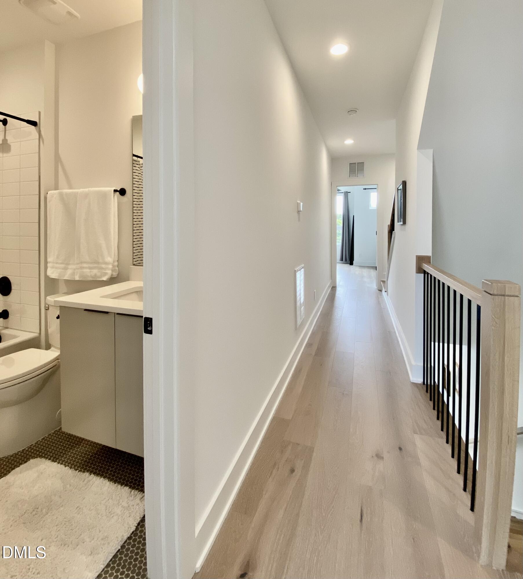 629 North Queen Street Durham, NC 27701 - Photo 35 of 58 a view of a hallway with wooden floor and a bathroom