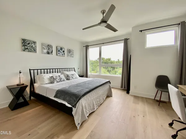 a bedroom with a bed and a table