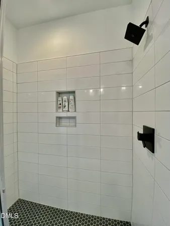a large bathroom with a double vanity sink a large mirror and shower