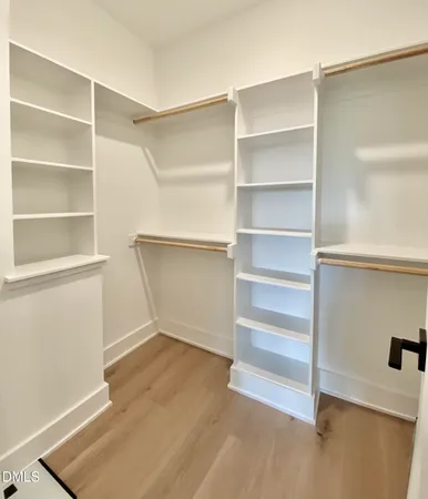 a view of a hallway with wooden floor and entryway