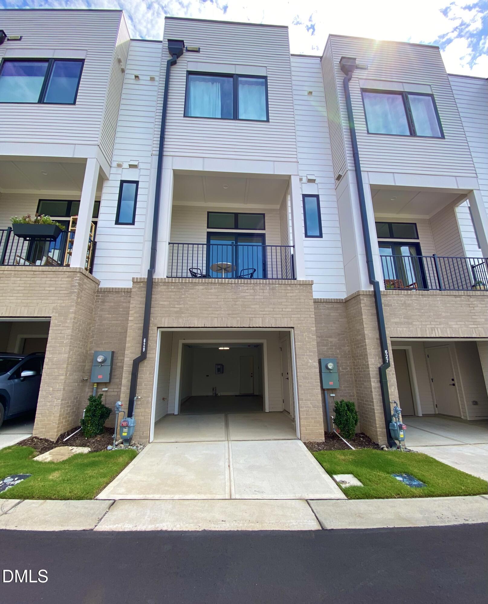 629 North Queen Street Durham, NC 27701 - Photo 53 of 58 a front view of a house with a yard and a garage