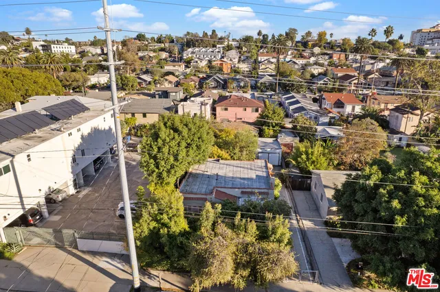an aerial view of residential houses with outdoor space