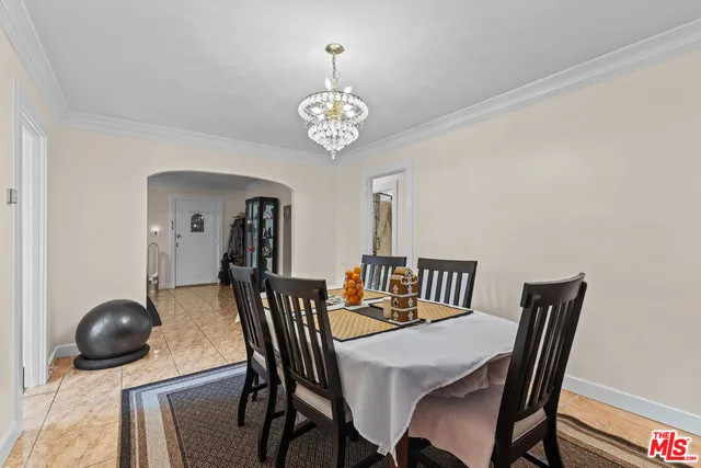 a view of a dining room with furniture and chandelier