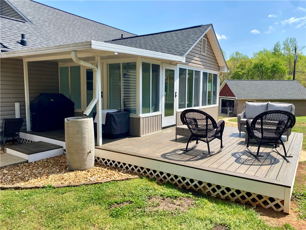 210 Twin Lakes Drive Anderson, SC 29621 - Photo 11 of 44 This inviting backyard deck with a screened porch offers a tranquil outdoor retreat.