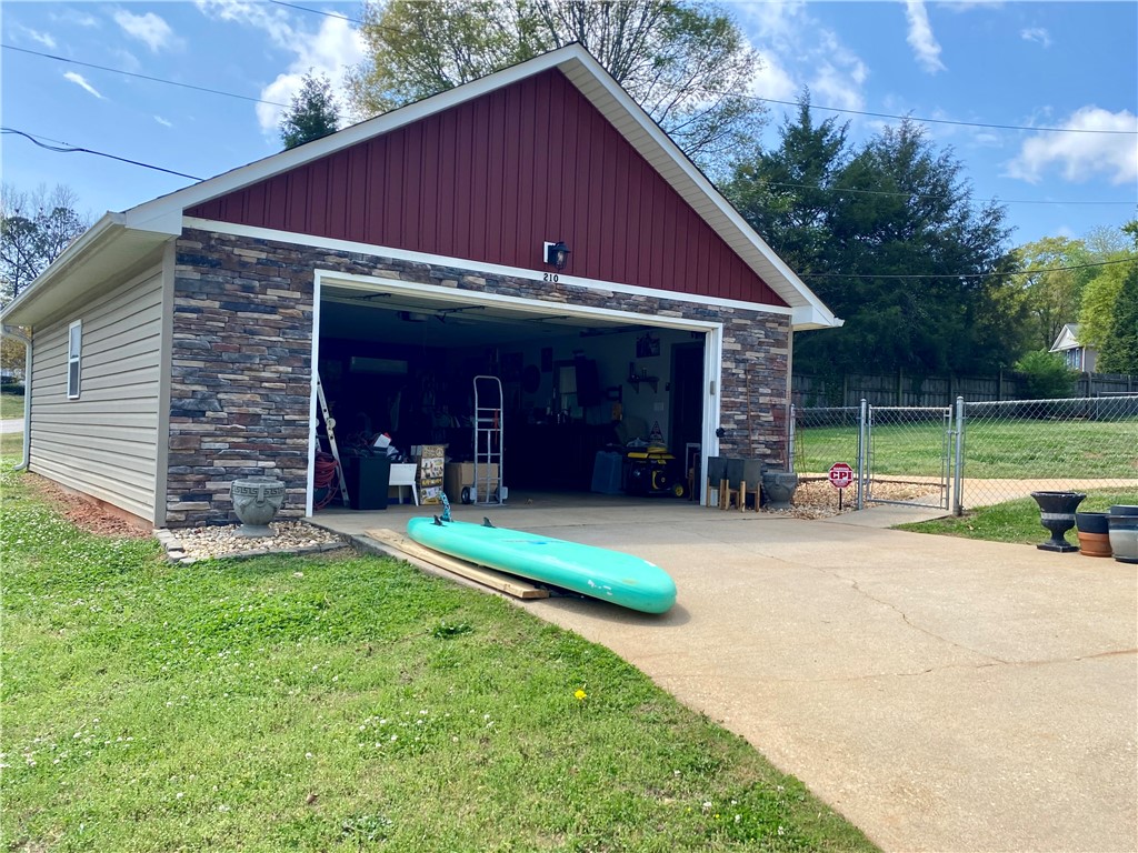 210 Twin Lakes Drive Anderson, SC 29621 - Photo 12 of 44 This functional garage offers ample space for vehicles and storage, complementing the home's exterior.