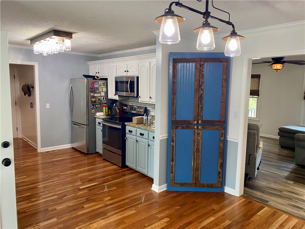 210 Twin Lakes Drive Anderson, SC 29621 - Photo 19 of 44 This charming kitchen boasts elegant crown molding, a built-in pantry, and durable hardwood flooring.