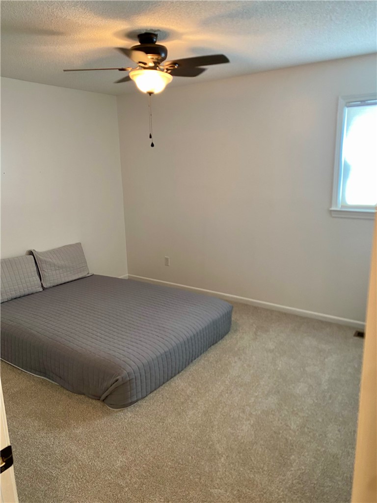 210 Twin Lakes Drive Anderson, SC 29621 - Photo 28 of 44 This cozy bedroom offers a tranquil retreat with soft carpet and natural light.