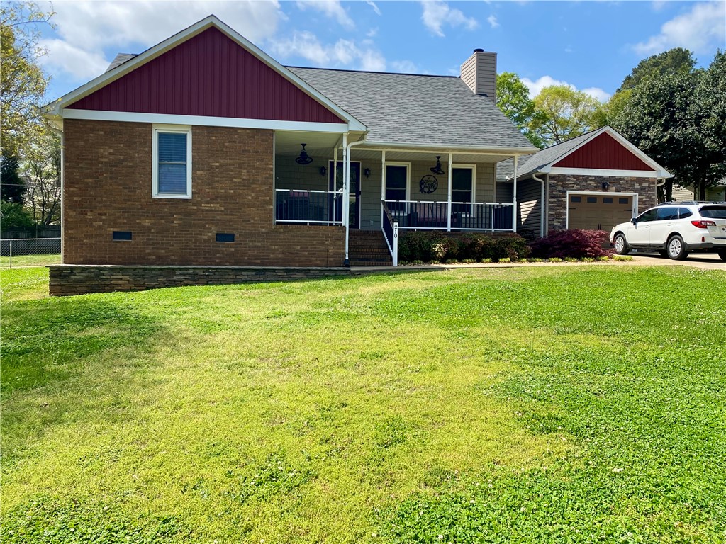 210 Twin Lakes Drive Anderson, SC 29621 - Photo 3 of 44 This charming home offers a welcoming facade with a cozy front porch and attached garage.