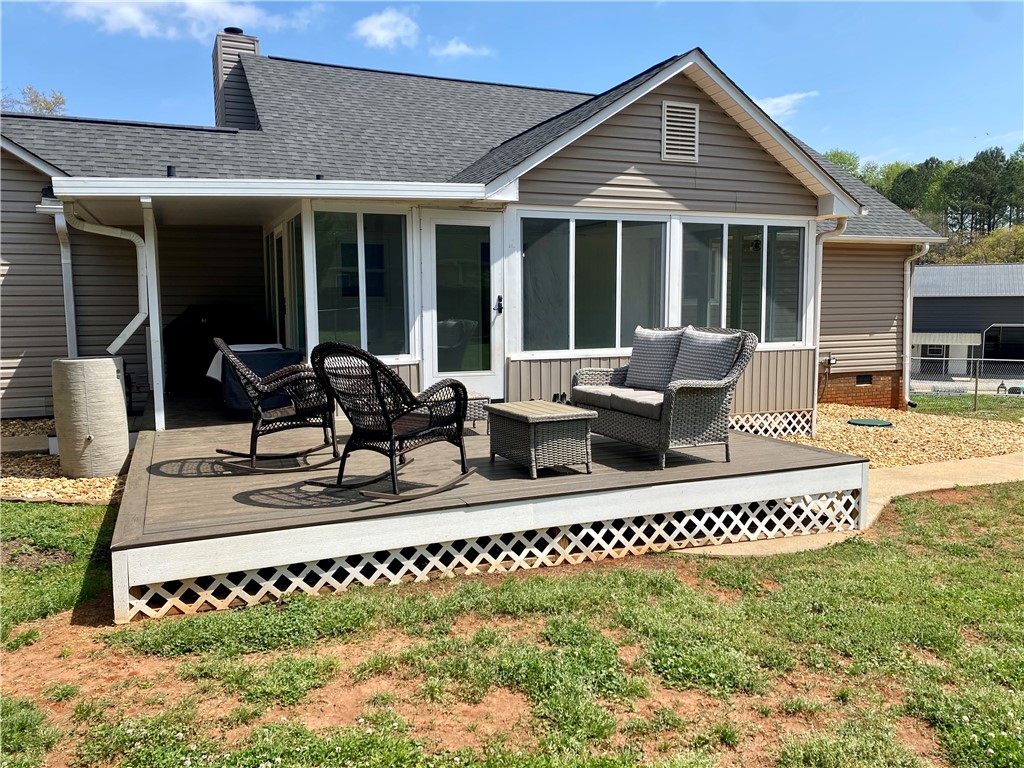 210 Twin Lakes Drive Anderson, SC 29621 - Photo 35 of 44 This inviting outdoor space features a spacious deck and sunroom, perfect for relaxation and enjoying the outdoors.