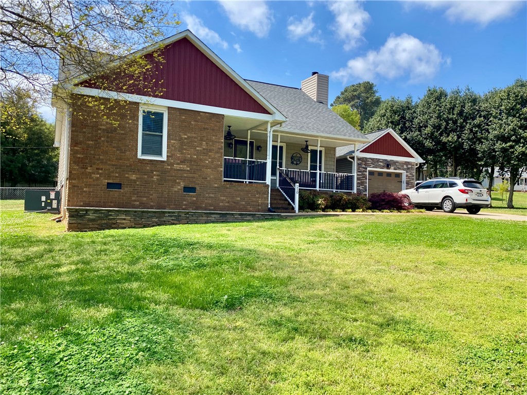 210 Twin Lakes Drive Anderson, SC 29621 - Photo 4 of 44 This charming home offers a welcoming facade with a covered porch and attached garage.