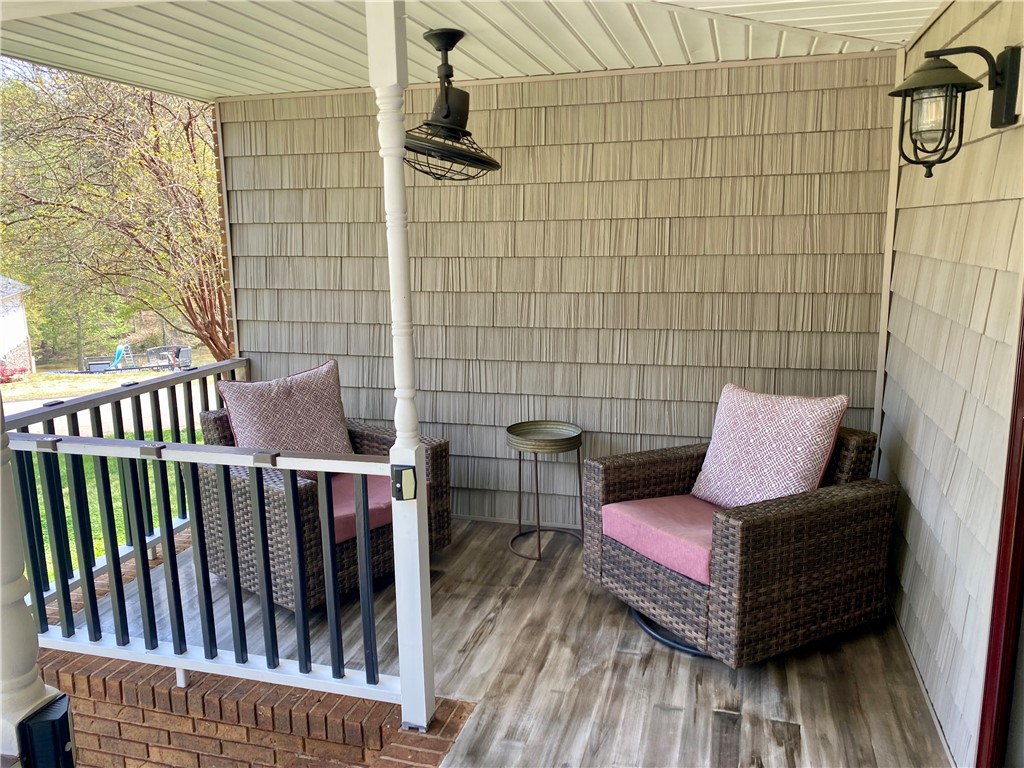 210 Twin Lakes Drive Anderson, SC 29621 - Photo 9 of 44 Relax on this charming covered porch, featuring durable flooring and inviting outdoor lighting.