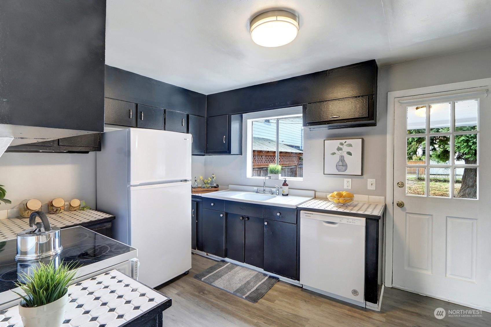 1718 Rockefeller Avenue Everett, WA 98201 - Photo 7 of 17 a kitchen with stainless steel appliances a refrigerator a sink a stove and cabinets