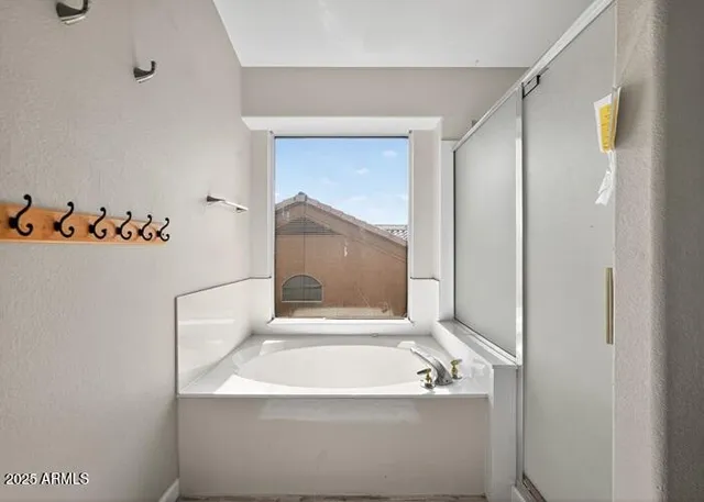 a bathroom with a bathtub and a shower