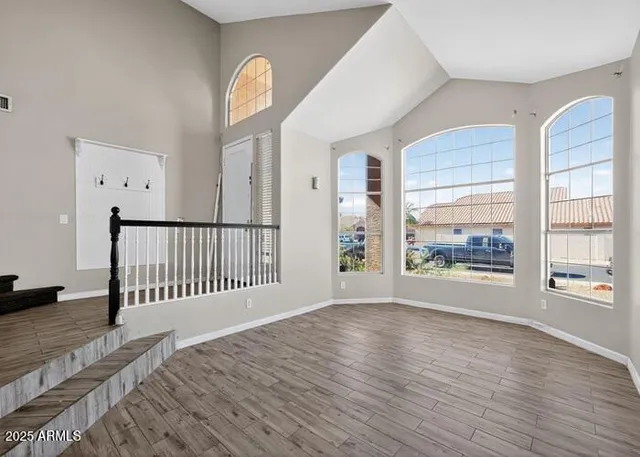 wooden floor in an empty room with a window