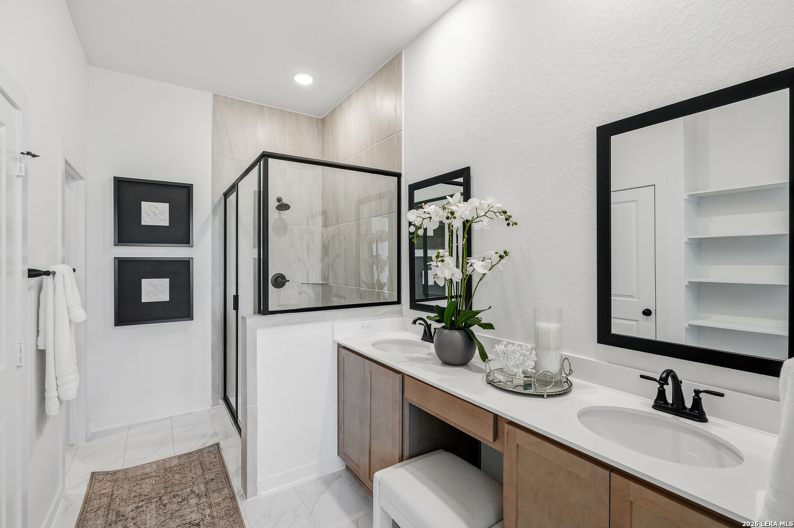 9421 Chatside Schertz, TX 78154 - Photo 13 of 48 a bathroom with a double vanity sink a mirror and shower
