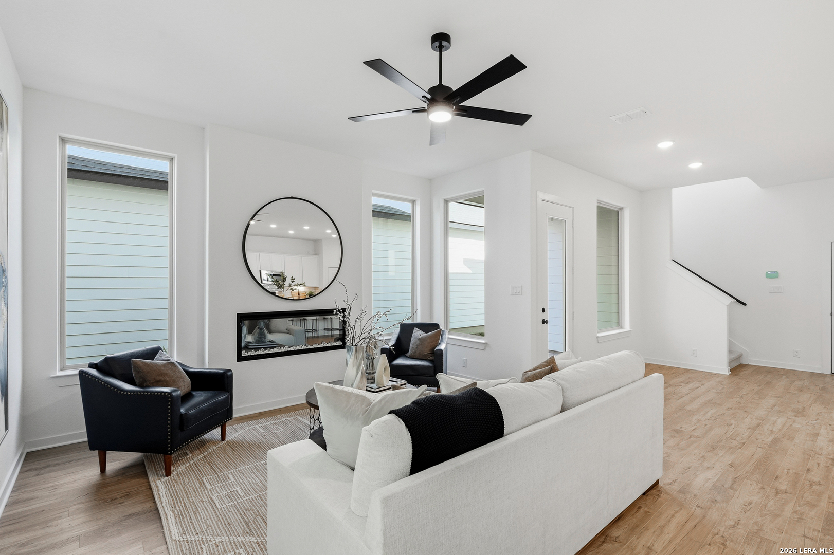 9421 Chatside Schertz, TX 78154 - Photo 18 of 48 a living room with furniture a clock potted plant and a ceiling fan